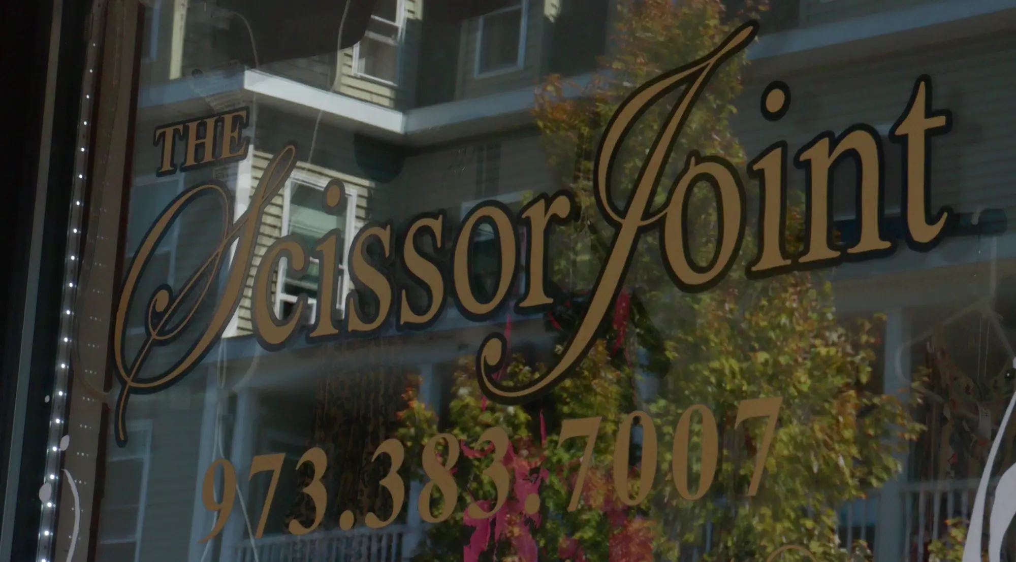 The Scissor Joint name painted across the storefront window