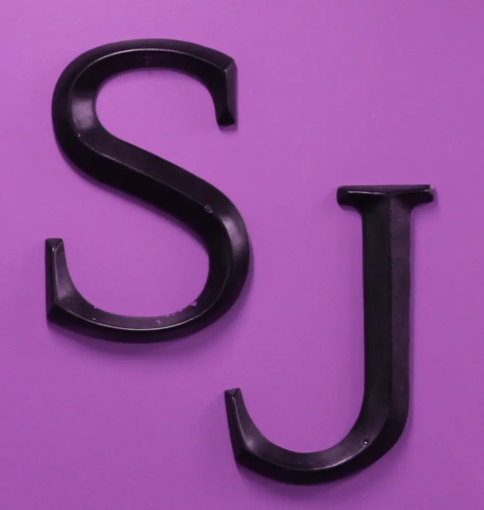 The Scissor Joint SJ logo on a purple background